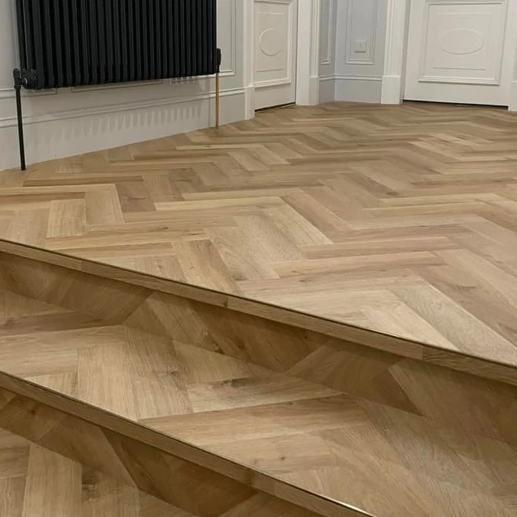 Herringbone-pattern floor and step detail in Transform’s public gallery